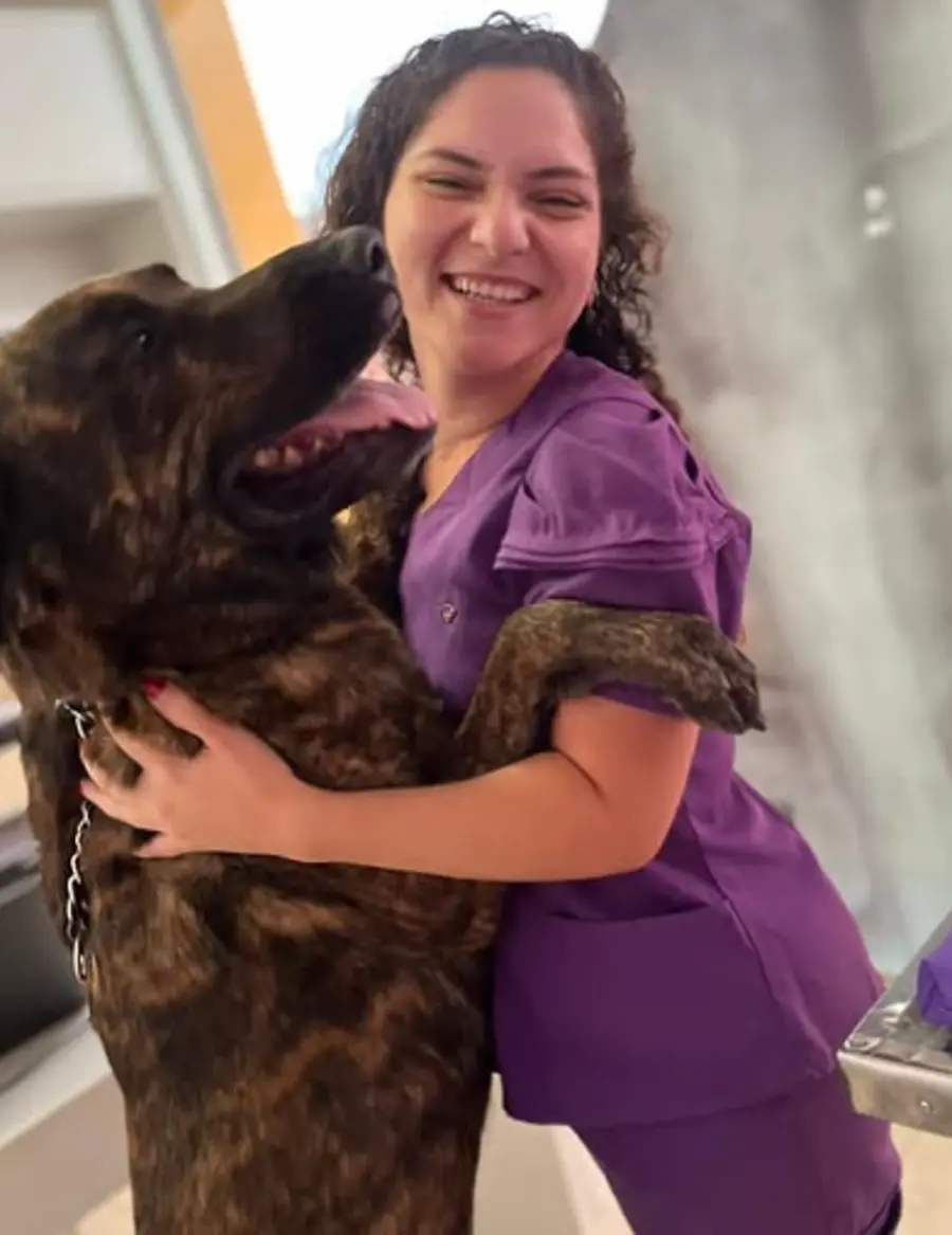Profissional da Nyupet com cachorro no colo